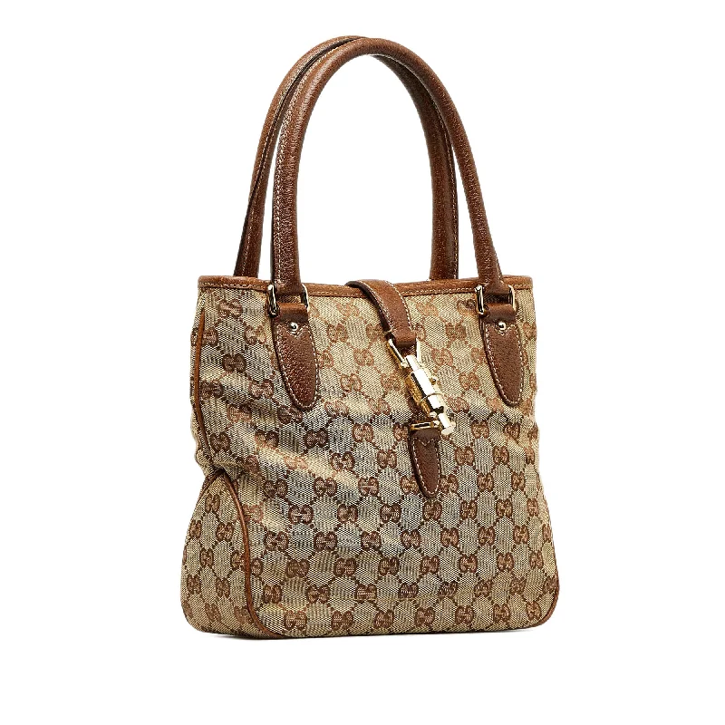 Women Gucci Sylvie bags with a crystal - embellished web stripeTan Gucci GG Canvas Jackie Piston Lock Tote Bag